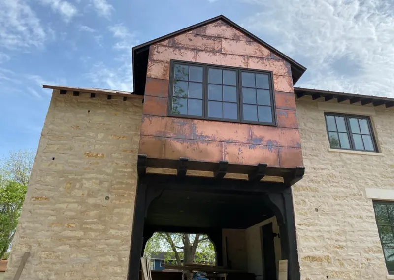 Copper metal panel facade on a stone building for Skylight Installation in North Middleton